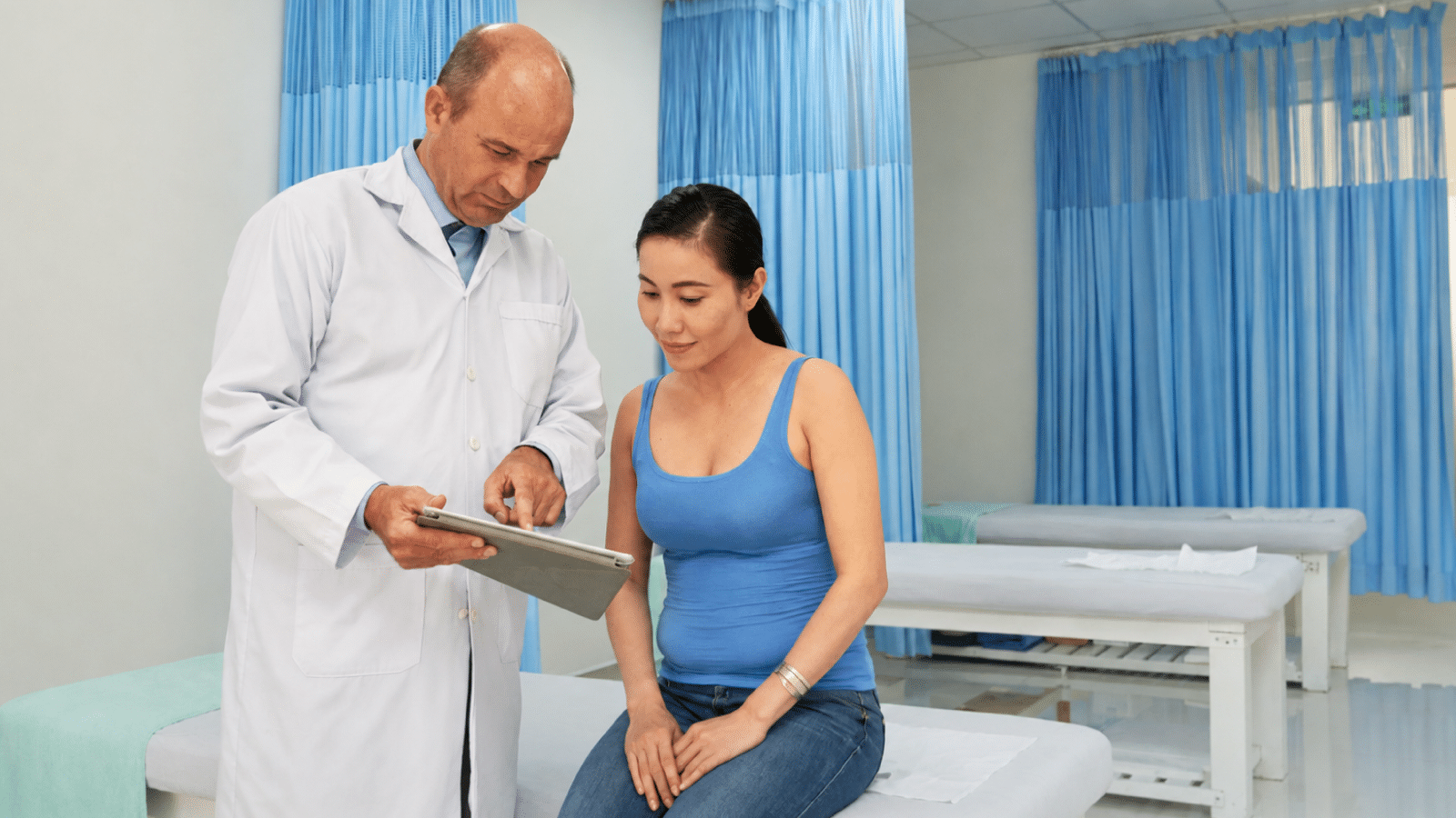 A doctor showing the report to a patient in the clinic - What Happens After an Abnormal Mammogram