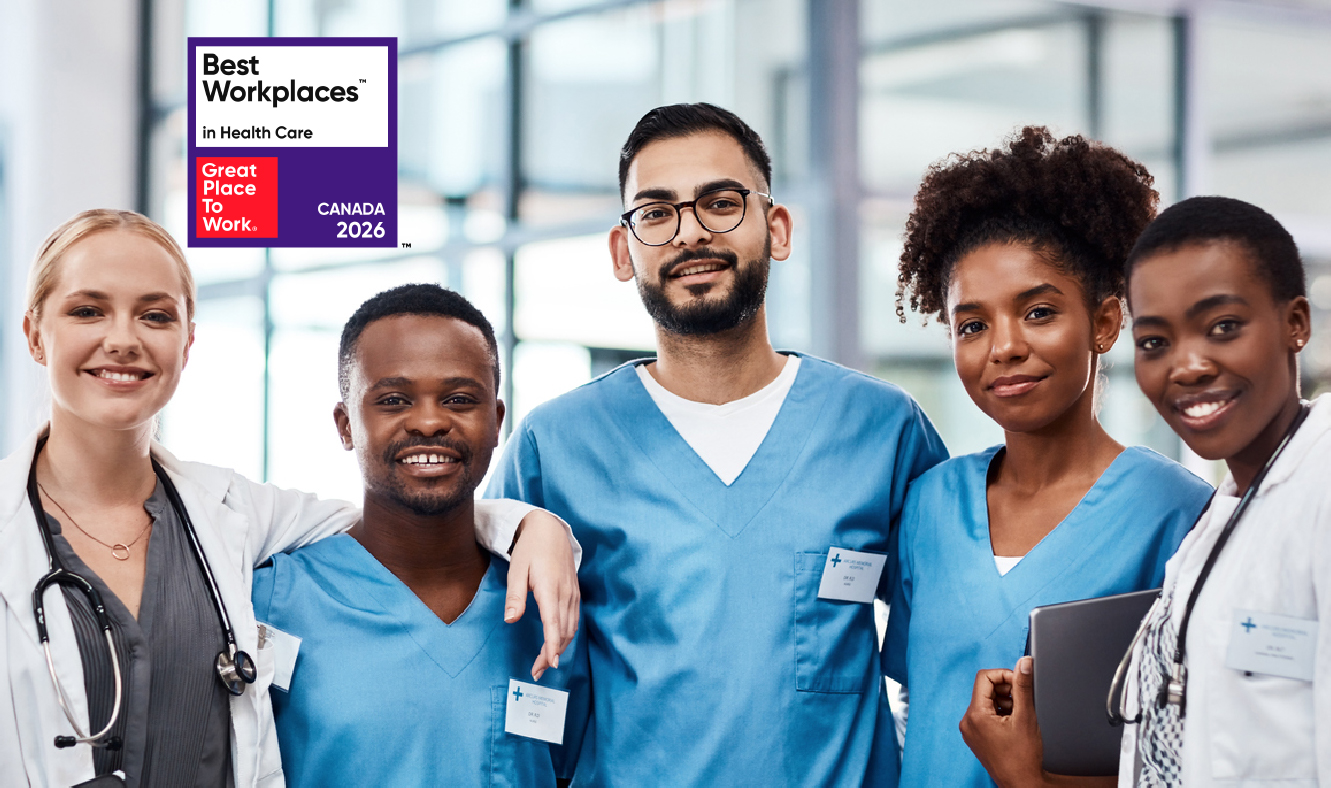 A group portrait of a diverse medical team, including doctors in white lab coats and nurses in blue scrubs, smiling together in a modern clinic or hospital setting. In the top left corner, there is a prominent badge that reads "Best Workplaces in Health Care - Great Place To Work - CANADA 2026".